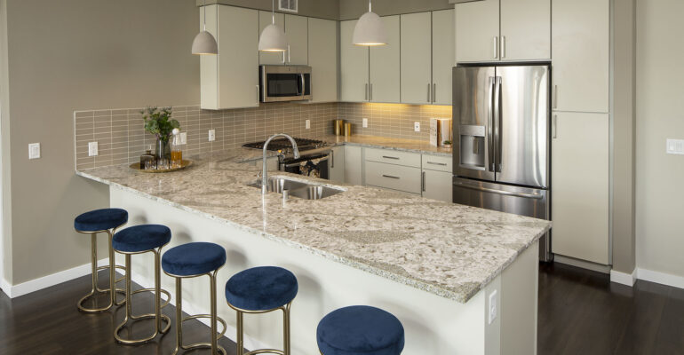 Chef’s kitchen with quartz countertops, gas range, pantry, designer backsplashes, and 42” European cabinets