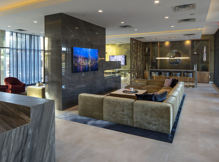 Luxurious club room with catering kitchen and bar with a wall-oven, warming drawers, refrigerators and ice makers, large screen TVs, elegant seating & games